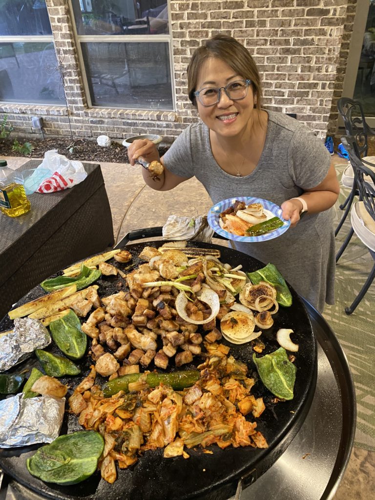 Mama enjoying the outdoor cooking with Dad